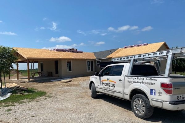 Roofing crew installing new asphalt shingles